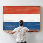 a man standing in front of a painting of the dutch flag