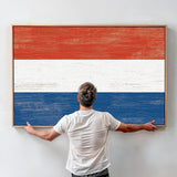 a man standing in front of a painting of the dutch flag