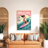 a framed poster of a woman surfing on a beach, with the text "BEACH LIFE" prominently displayed. The poster is hung on a wall above a brown leather couch, which is positioned in front of two potted plants.
