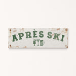 A weathered sign with the text "APRES SKI" in green letters, along with icons of a beer glass and a martini glass, indicating a location or establishment related to skiing and alcoholic beverages.