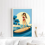 A framed illustration of a woman paddleboarding on a calm body of water, with a blue sky and trees in the background.