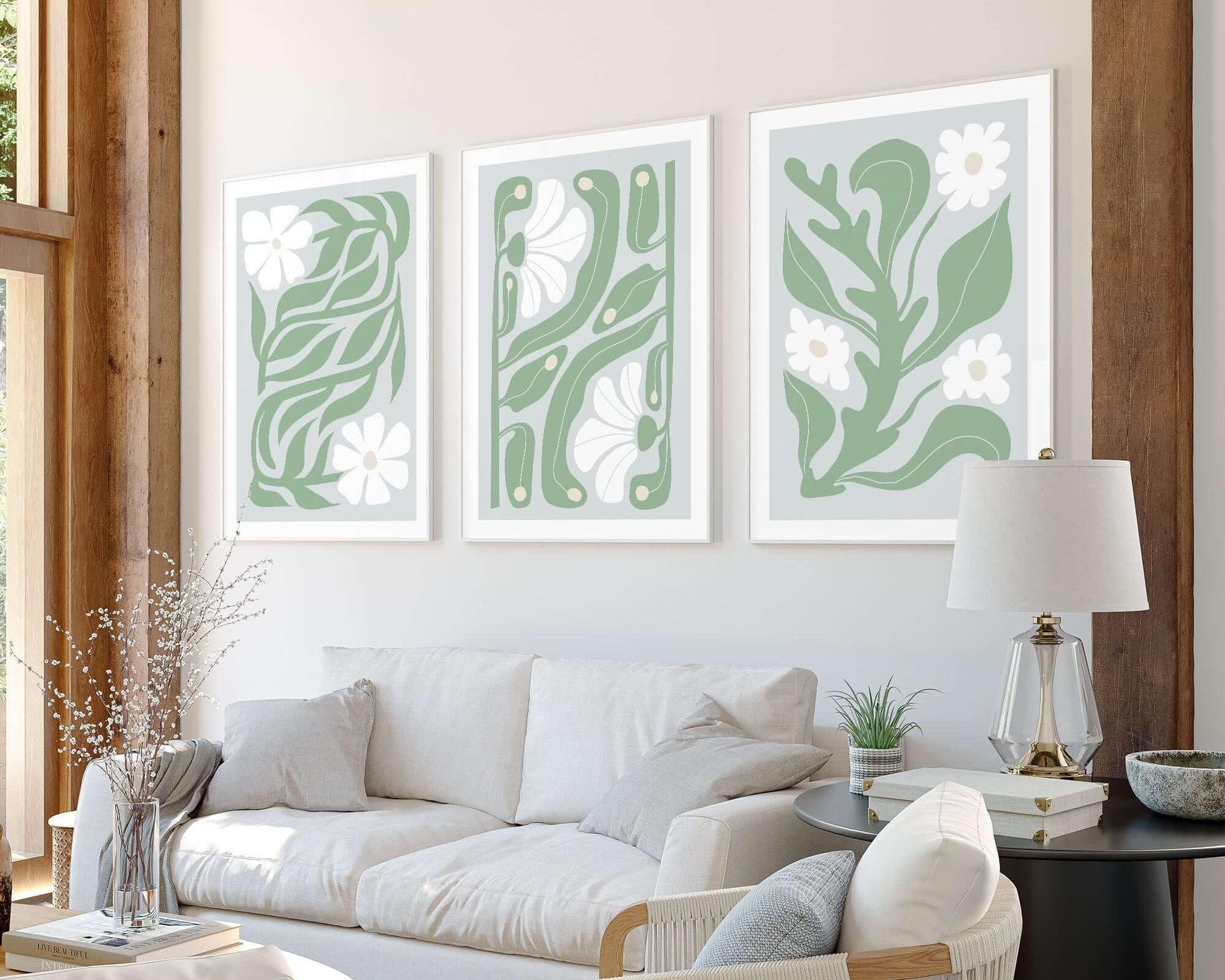 Bright living room featuring a modern beige sofa, white armchair, and the Flower Blocks Triptych | Set of Three Prints | 016—striking abstract green floral wall art perfect for elevating your home decor.
