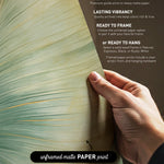 The image is a hand holding a piece of paper with text and a graphic of a leaf.