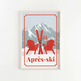 A framed poster depicting two red Adirondack chairs with skis in the foreground, set against a snowy mountain landscape with ski equipment.