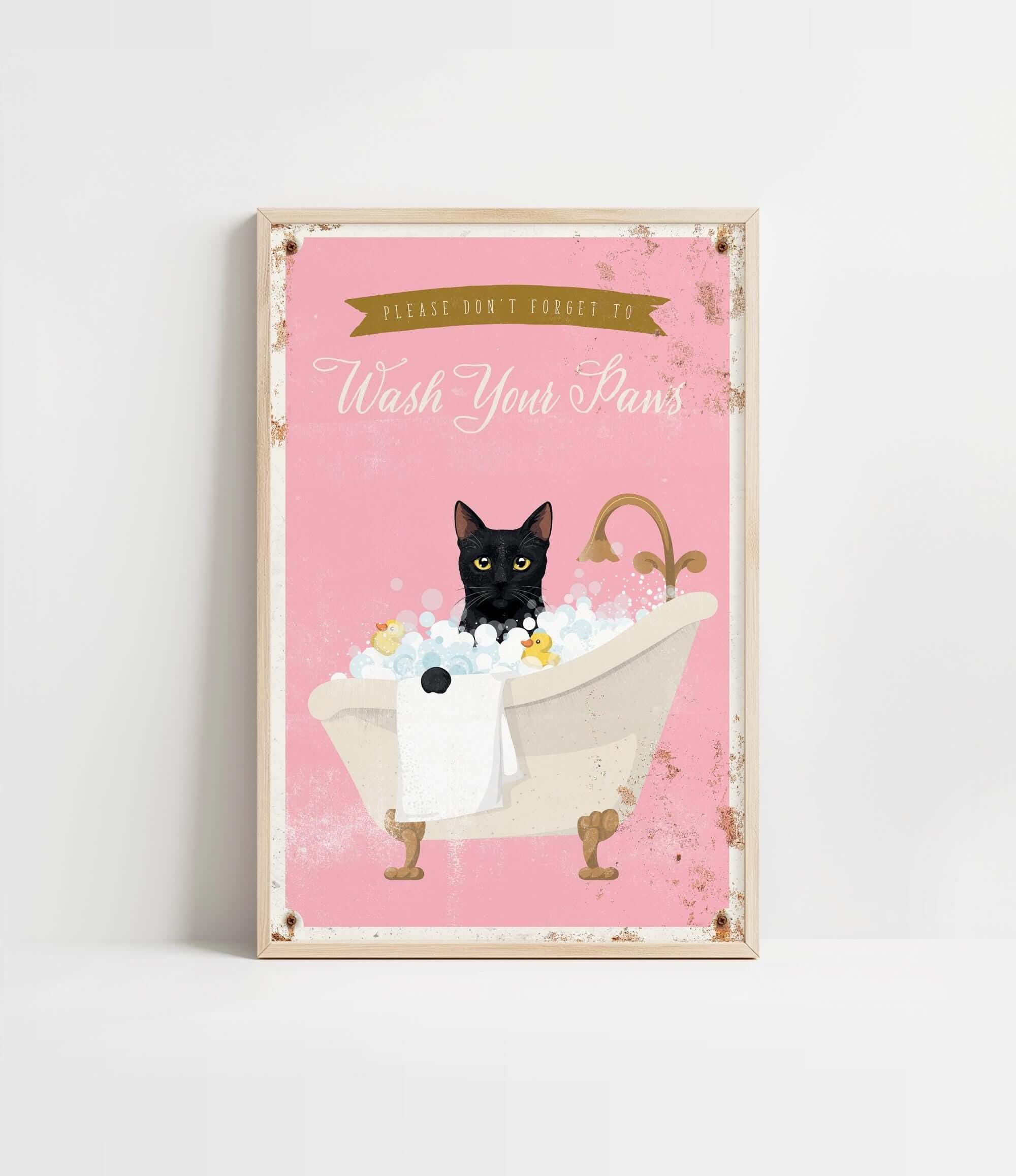 A framed poster with a black cat sitting in a bathtub filled with bubbles, accompanied by the text "Please don't forget to wash your pans".