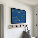 a blue and yellow flag hanging on a wall