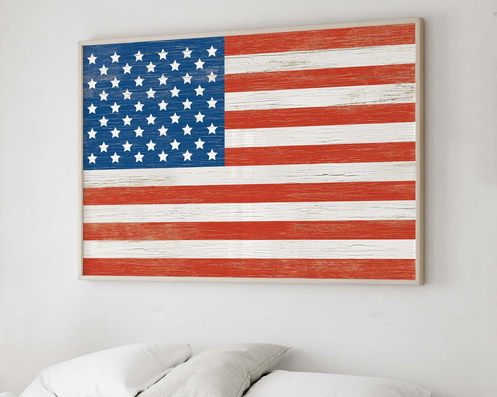 an american flag is hanging on a wall above a bed