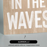 a wooden sign that says in the waves