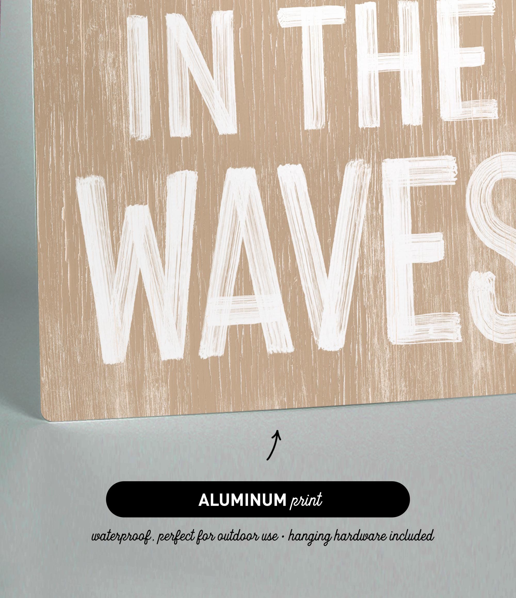 a wooden sign that says in the waves