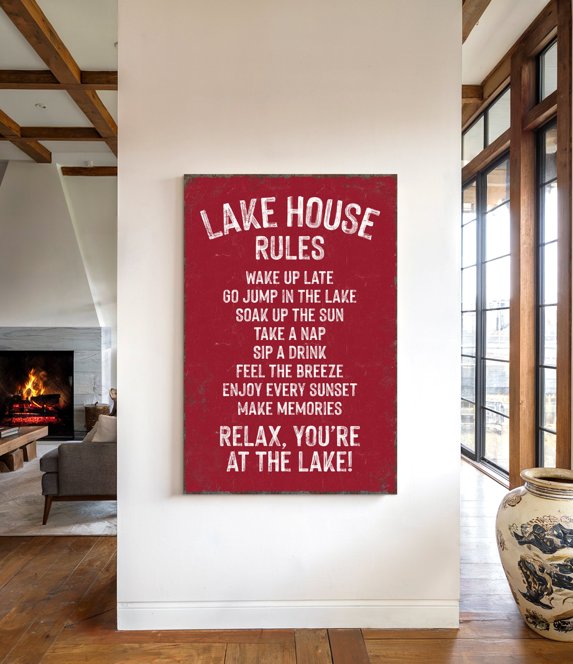a red sign with white text that reads "LAKESHOUSE RULES" hanging on a white wall.