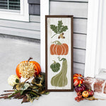 a picture of pumpkins and gourds on a porch