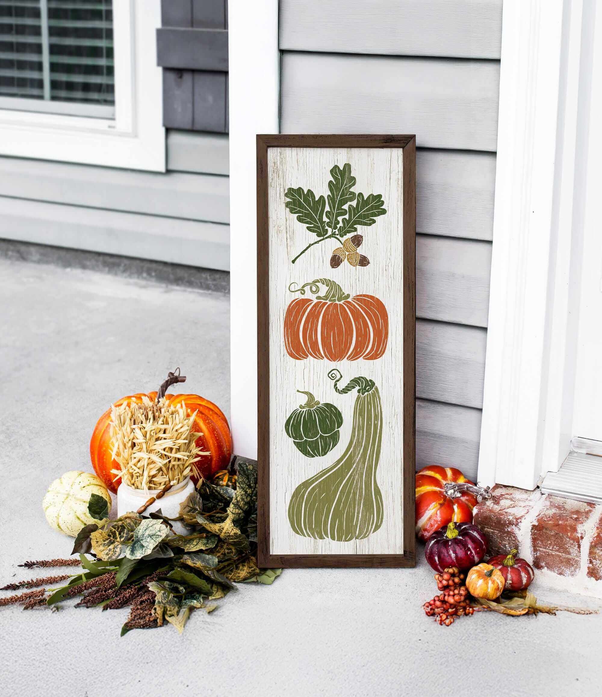 a picture of pumpkins and gourds on a porch