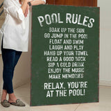 a woman standing next to a pool rules sign