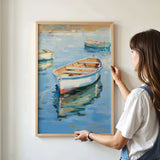 A woman is standing in front of a painting that depicts several boats floating on a body of water.