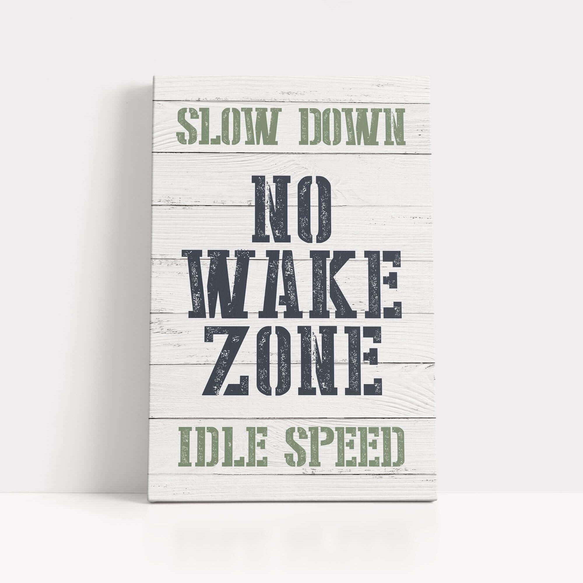 a wooden sign that says slow down no wake zone