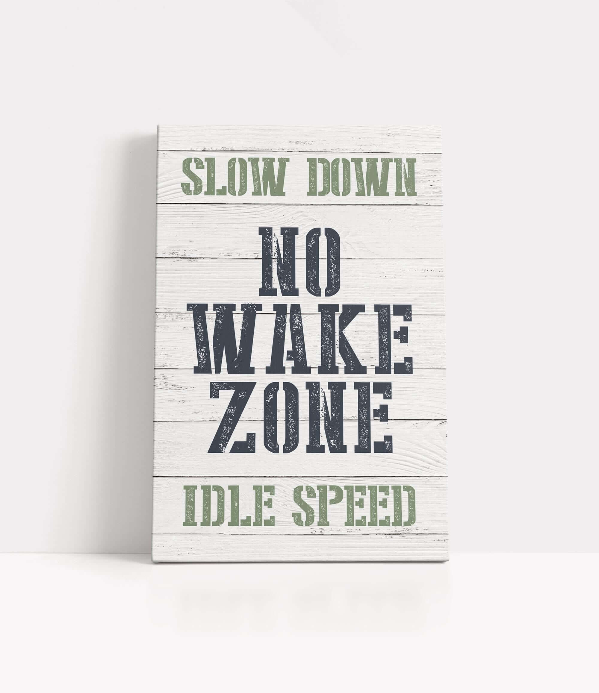 a wooden sign that says slow down no wake zone