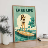 a framed poster of a woman paddleboarding on a lake, with the text "LAKELIFE" prominently displayed.