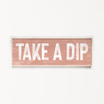 a wooden sign that says take a dip