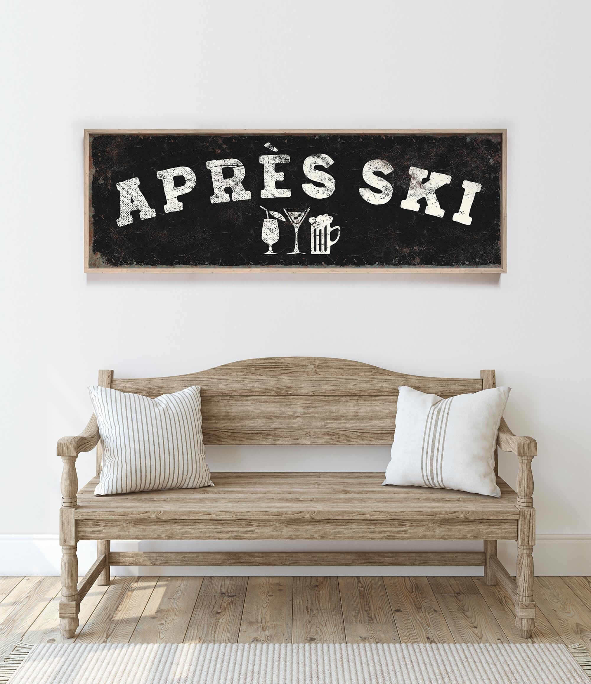 a wooden bench with two striped pillows, and above it is a framed sign with the text "APRÈS SKI" and various icons representing drinks and skiing equipment.