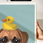 A hand is holding a framed print featuring a cartoon image of a dog with a yellow rubber duck on its head.