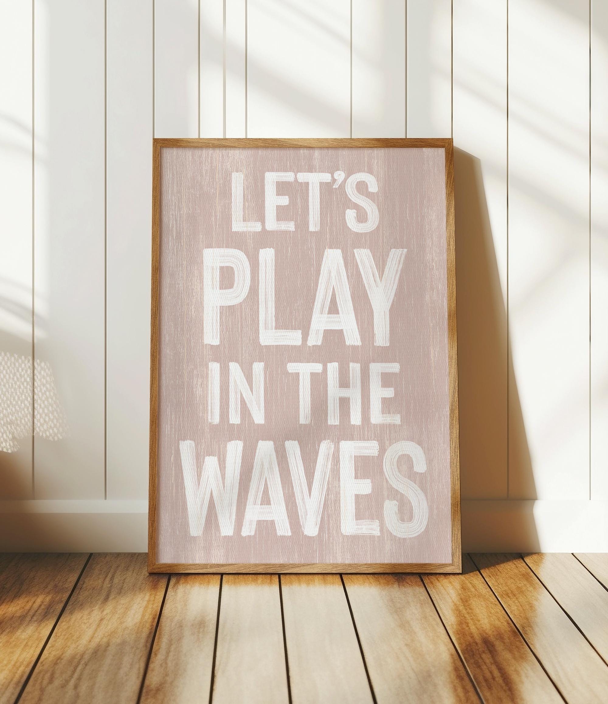 a wooden sign that says let&#39;s play in the waves