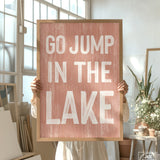 a person holding a sign that says go jump in the lake