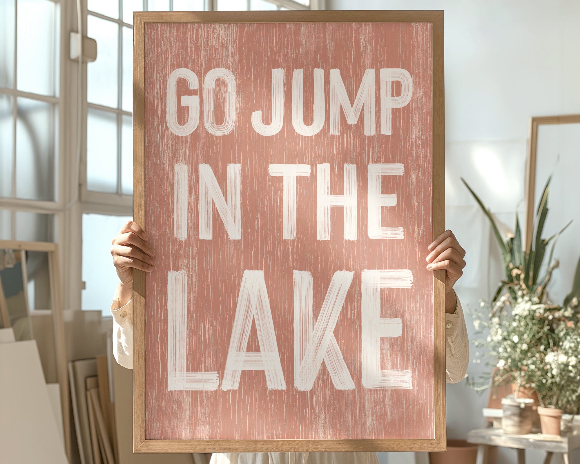a person holding a sign that says go jump in the lake