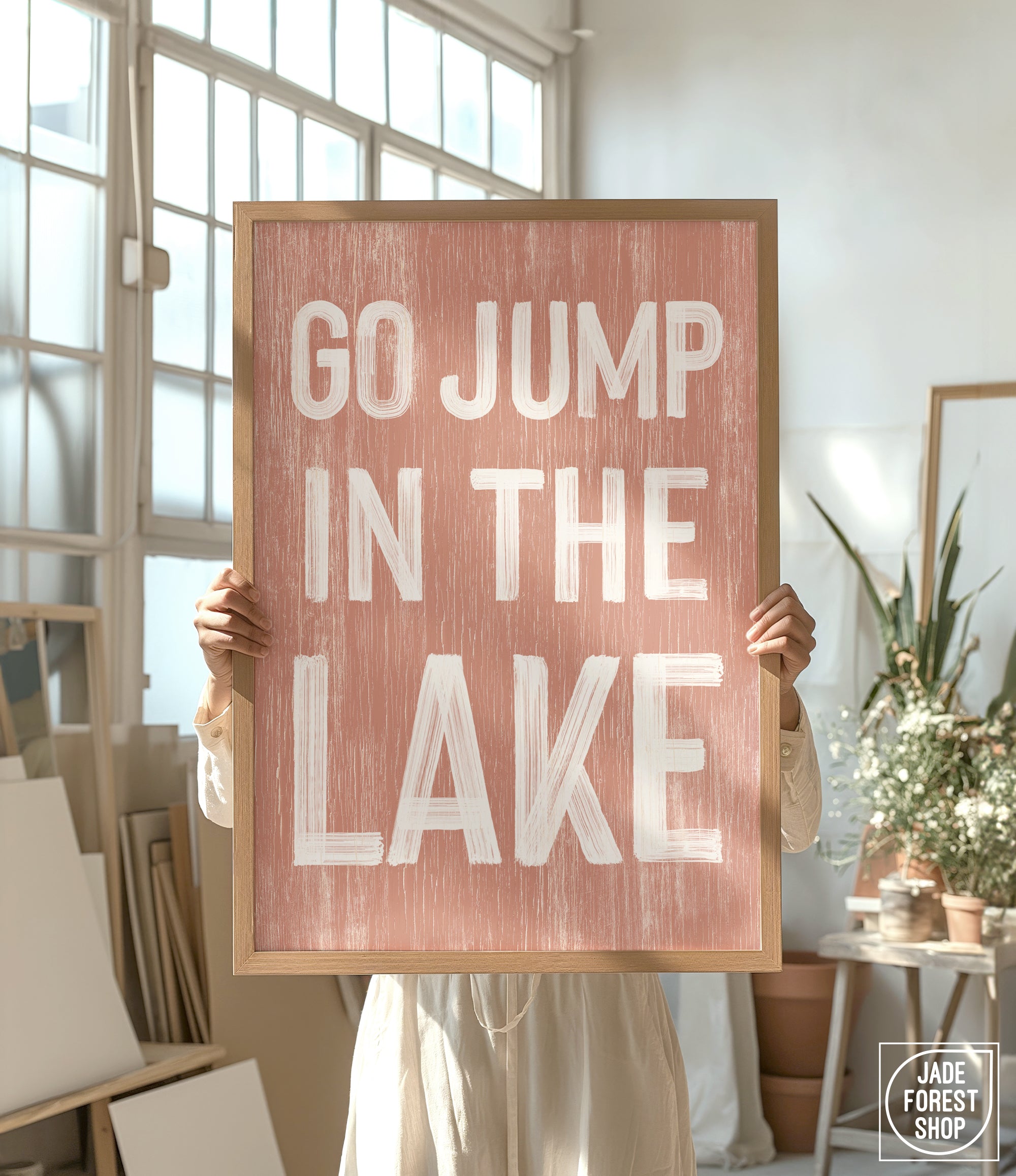 a person holding a sign that says go jump in the lake