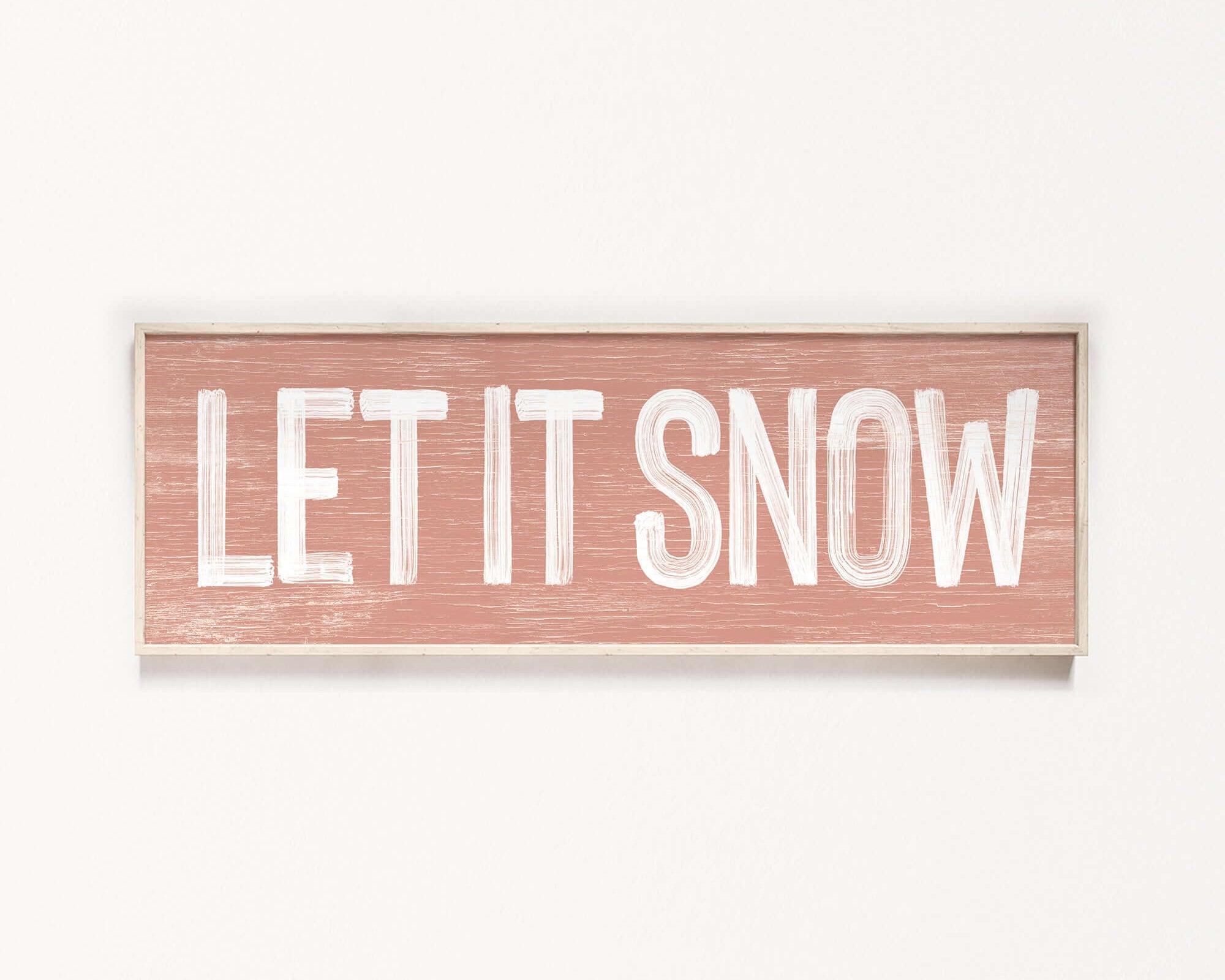 a wooden sign that says let it snow