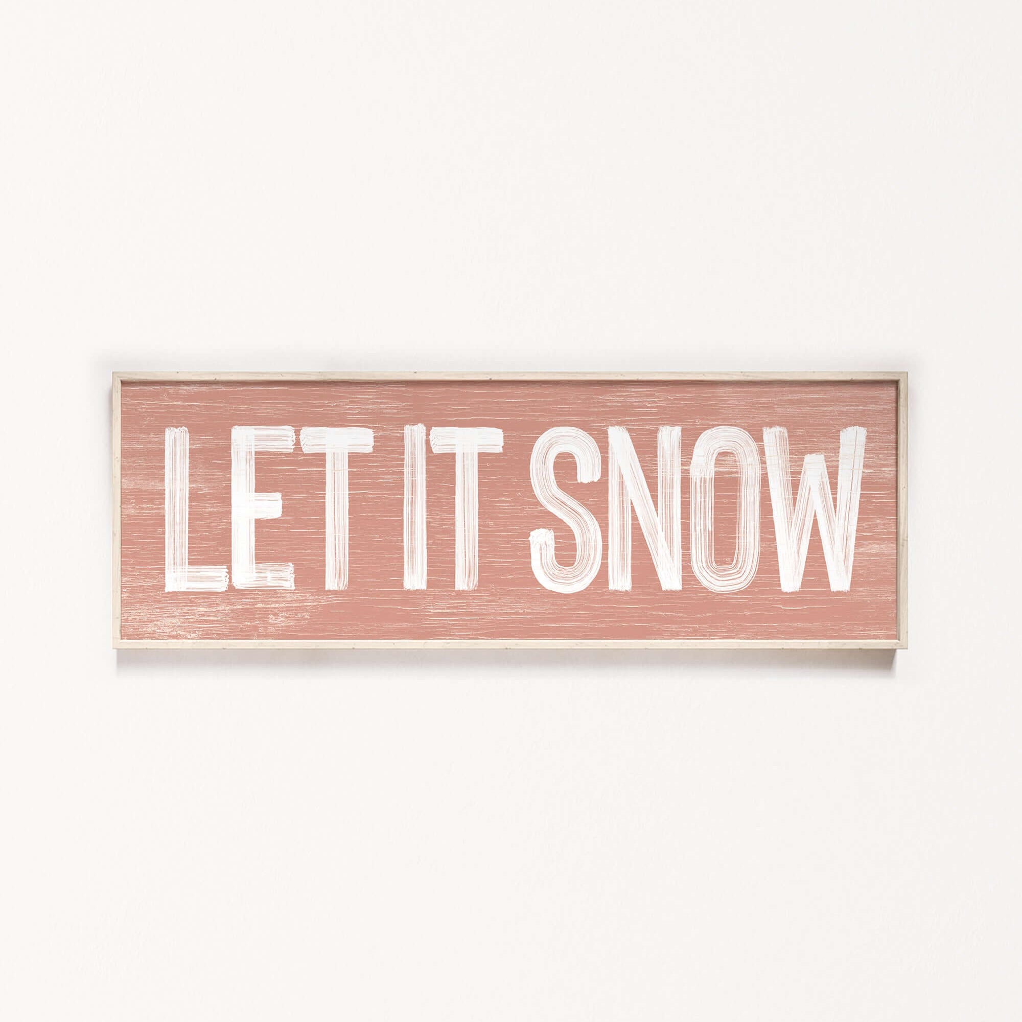 a wooden sign that says let it snow