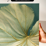 a close-up view of a large, intricate leaf with a textured surface and a vibrant green color.