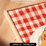 a close-up view of a canvas print with a red and white checkered pattern, placed on a wooden surface.