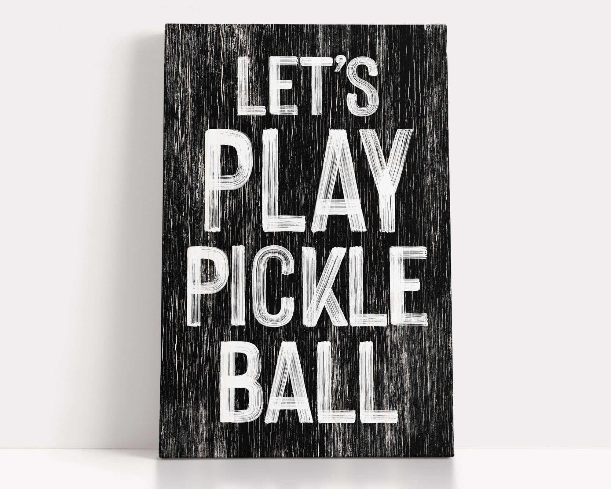 a wooden sign that says let's play pickle ball