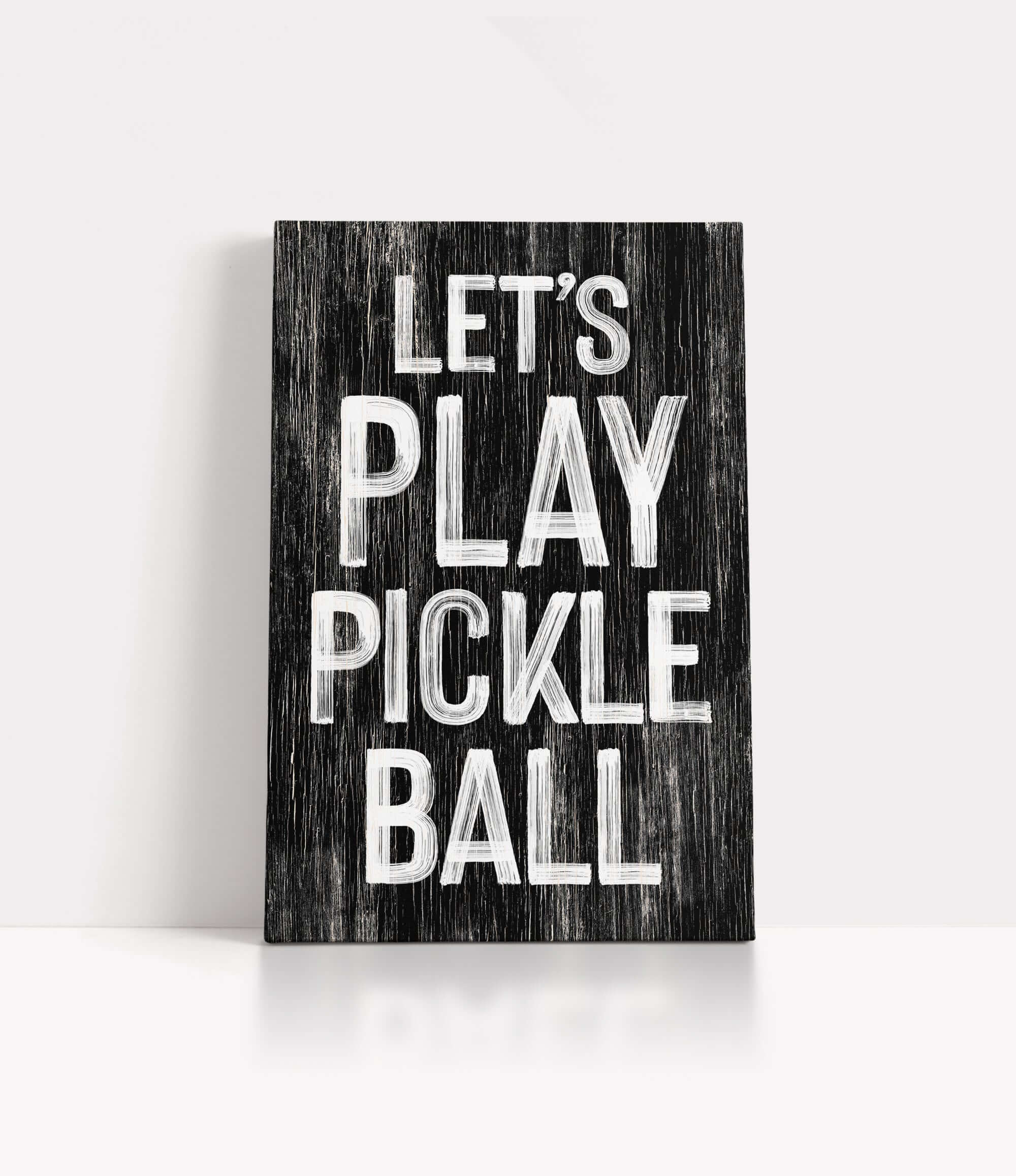 a wooden sign that says let's play pickle ball