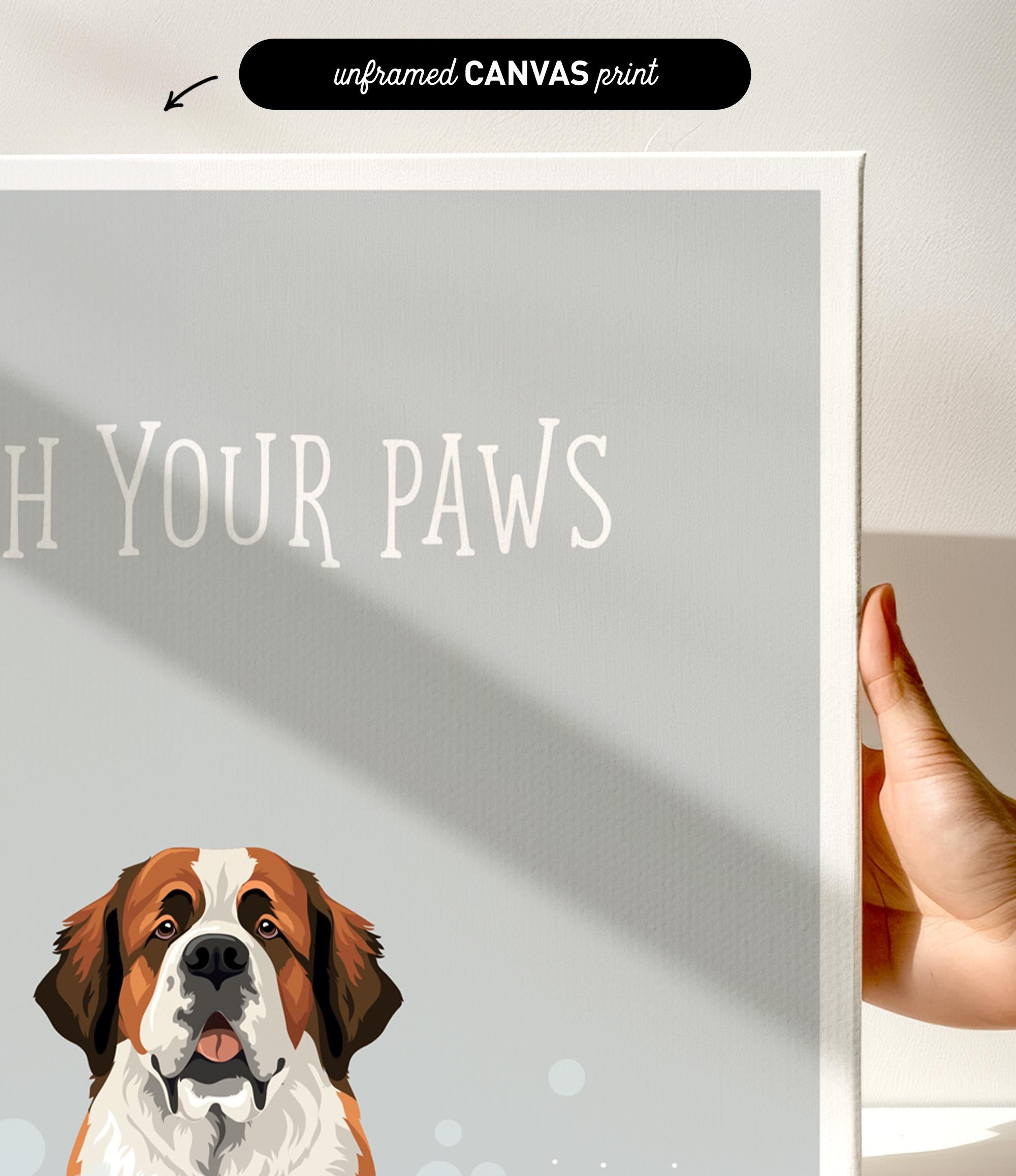 a hand holding a framed print of a dog's face, with the text "Wash Your Paws" written on the print.