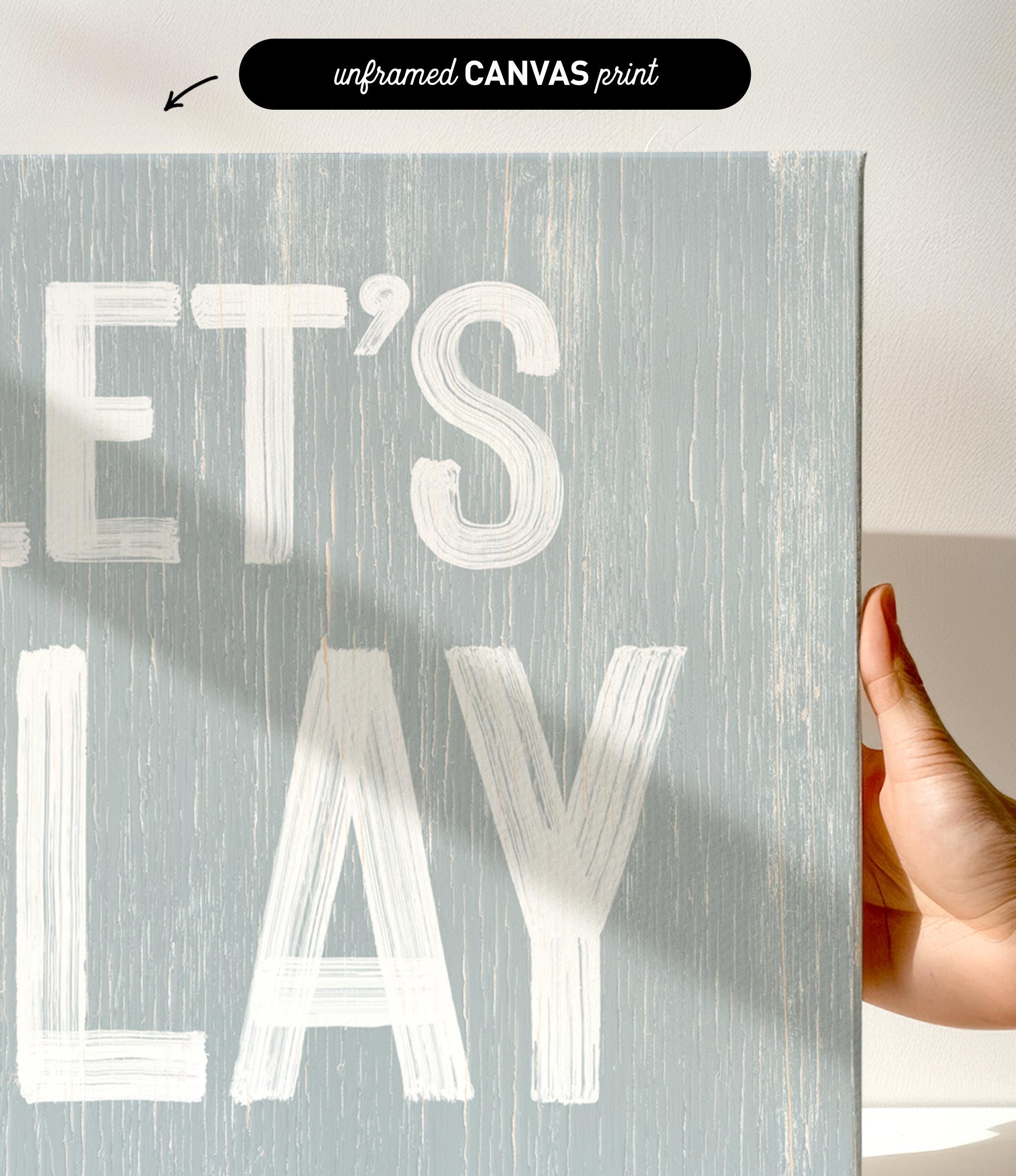a hand holding a sign that says let&#39;s play