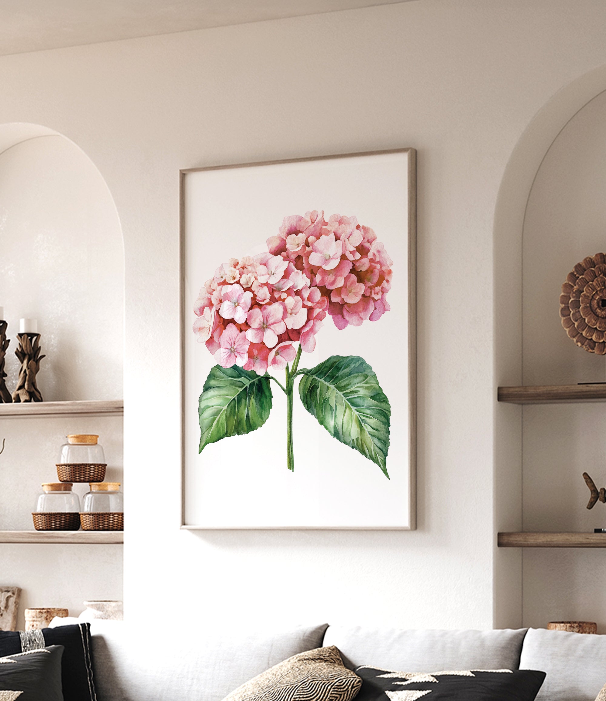 a framed painting of a pink hydrangea flower hanging on a wall in a living room.