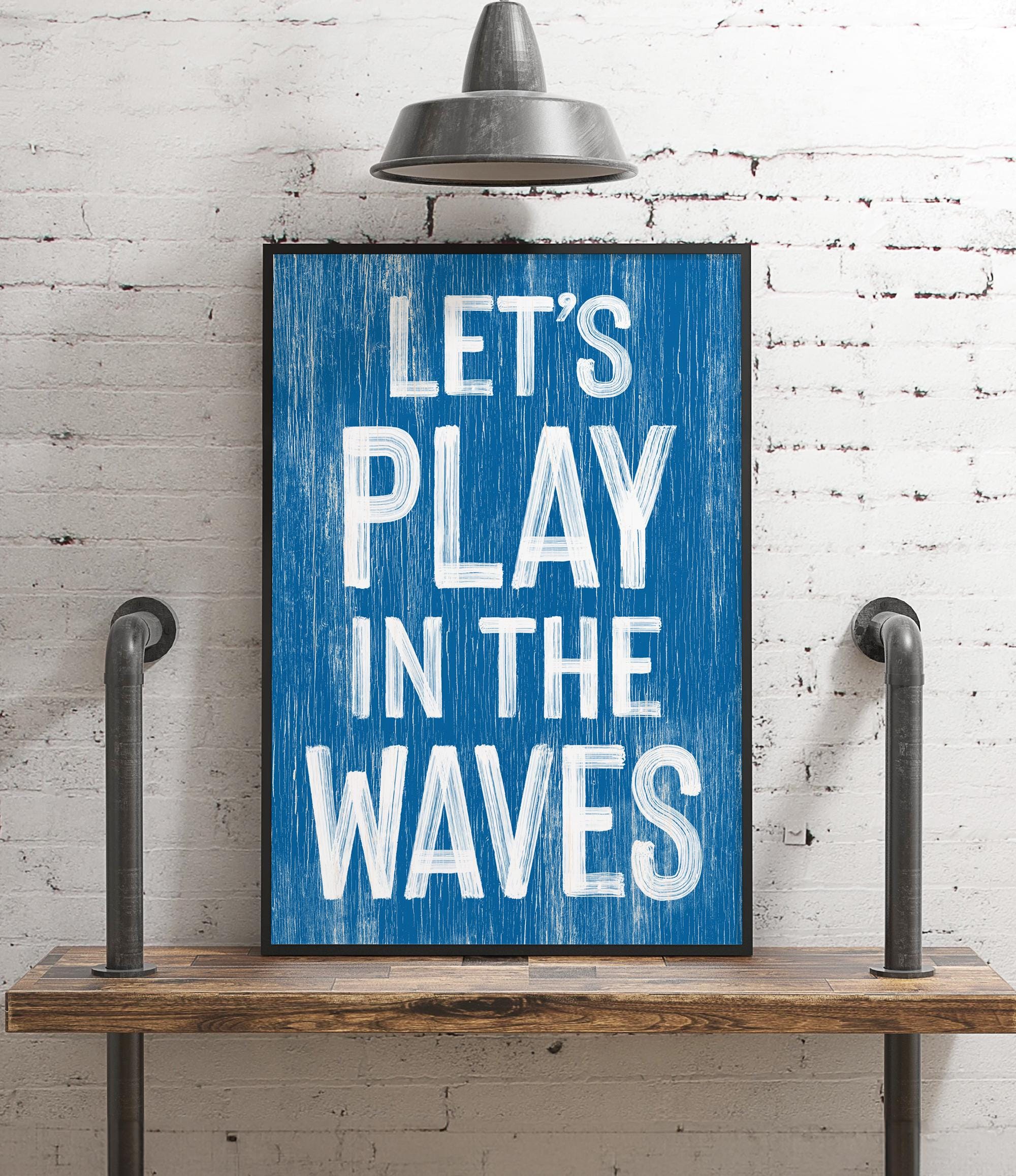 a blue sign that says let&#39;s play in the waves