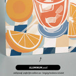 The image is an aluminum print featuring a vibrant illustration of a glass of orange juice with slices of orange and ice cubes.
