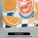 The image is an aluminum print featuring a vibrant illustration of a glass of orange juice with slices of orange and ice cubes.