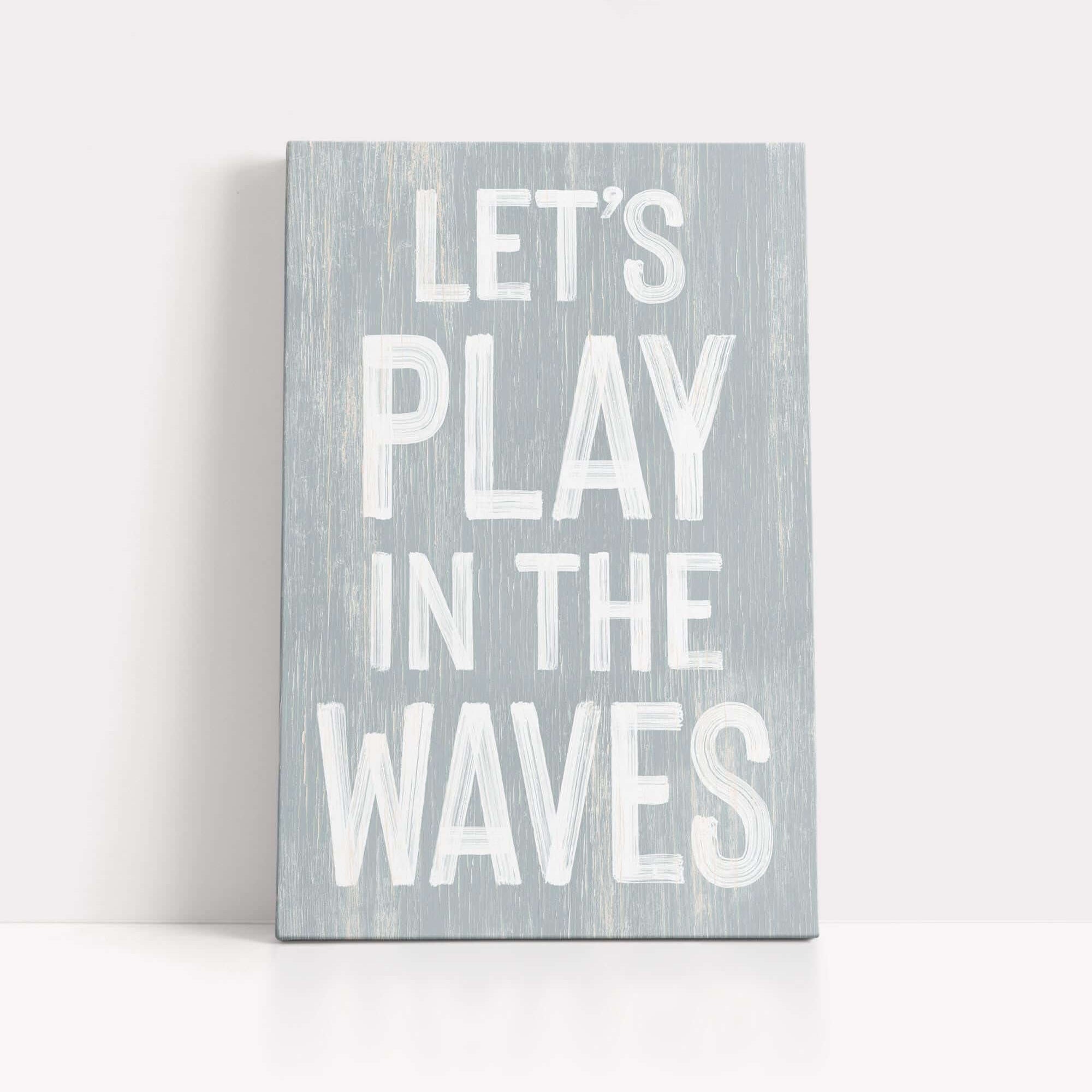 a wooden sign that says let's play in the waves