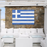 a white couch sitting under a blue and white flag