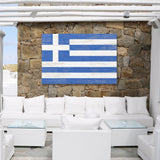 a white couch sitting under a blue and white flag