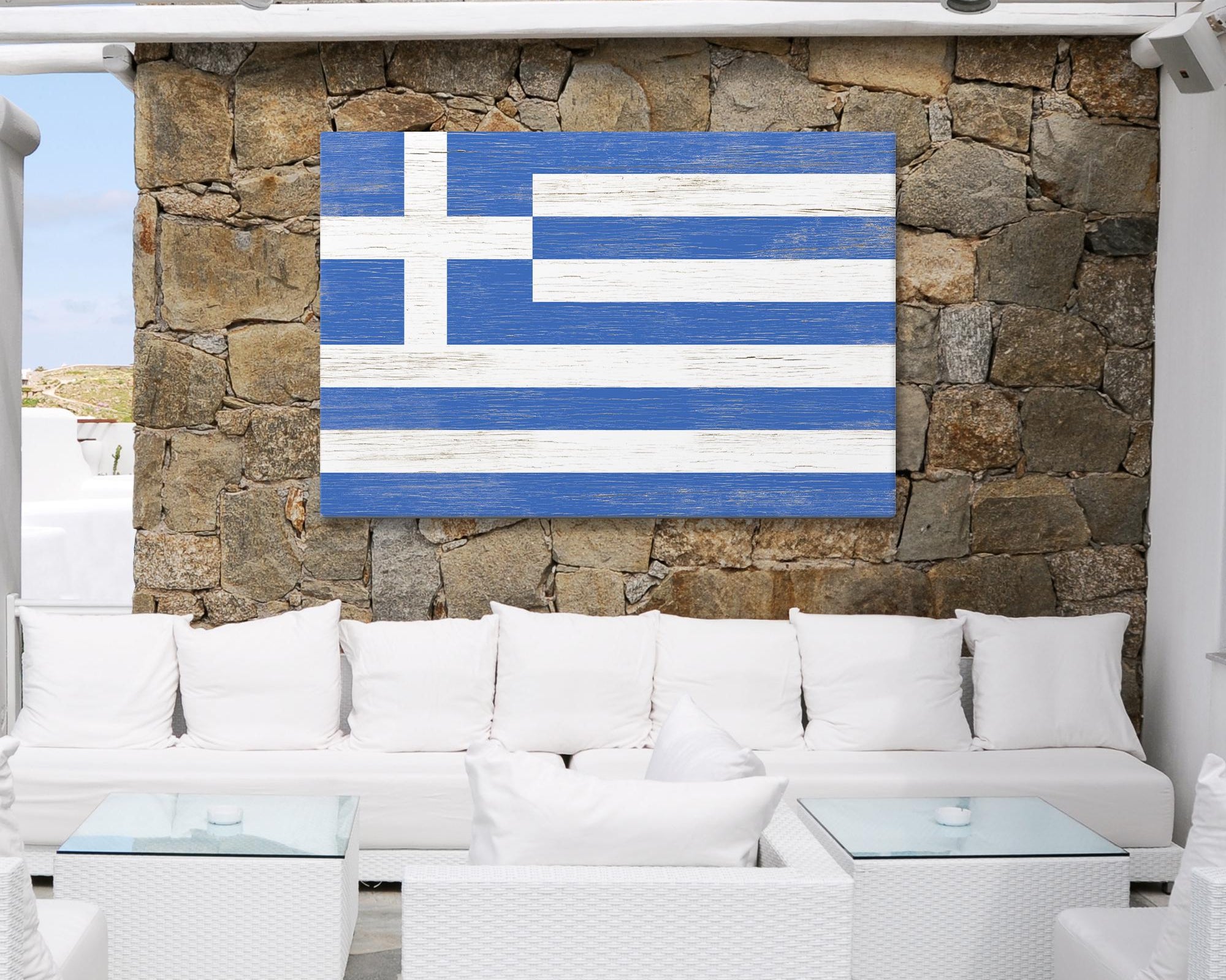 a white couch sitting under a blue and white flag