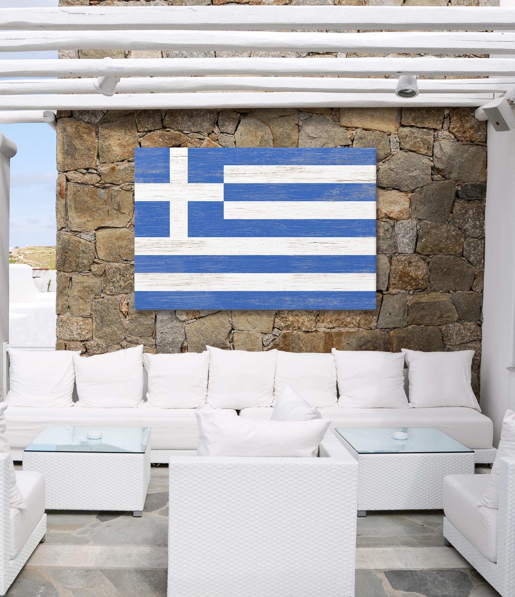 a white couch sitting under a blue and white flag