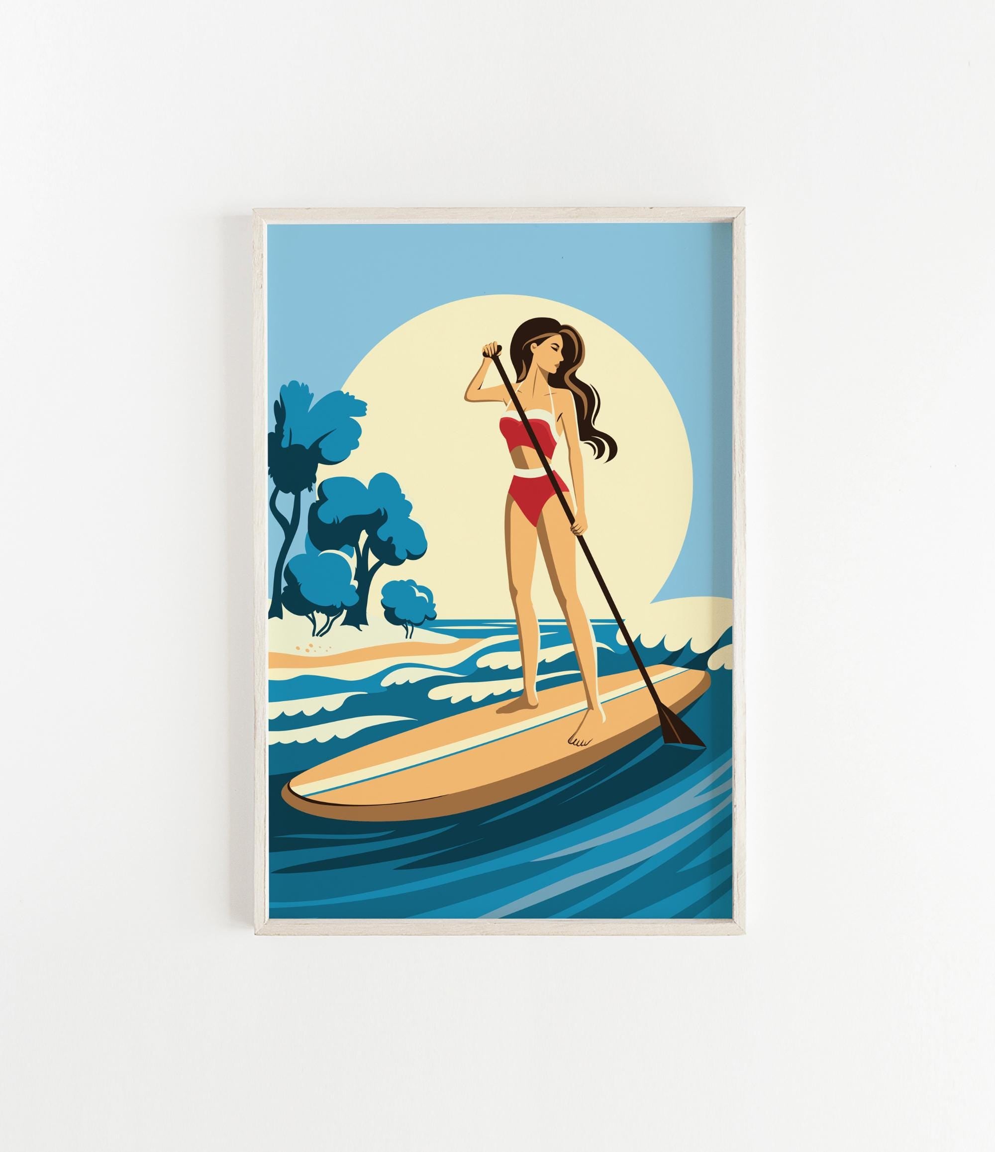 A woman in a red swimsuit is paddleboarding on a blue ocean, holding a paddle and standing on a surfboard.