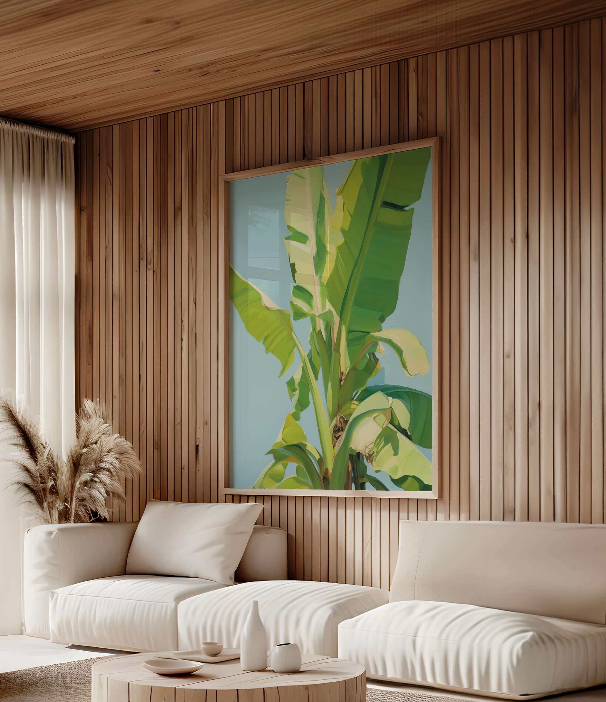 a modern living room with a large, vibrant painting of a banana tree hanging on the wall. The room is furnished with two white sofas and a coffee table, creating a cozy and inviting atmosphere.