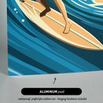 A surfer riding a wave on a surfboard, with a text overlay indicating that the image is an "ALUMINUM print" that is "waterproof, perfect for outdoor use - hanging hardware included".