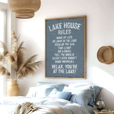 a bedroom with a large sign that reads "LAKESHORE RULES" hanging on the wall. The sign provides a list of rules for guests at the lake, including instructions to wake up late, go for a swim, take a nap, drink a beverage, enjoy the breeze, and relax. The room has a comfortable bed, a potted plant, and a woven basket on the wall, creating a cozy and inviting atmosphere.