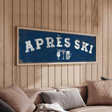a blue sign with white text that says "APRÈS SKI" hanging on a wooden wall above a couch with pillows.